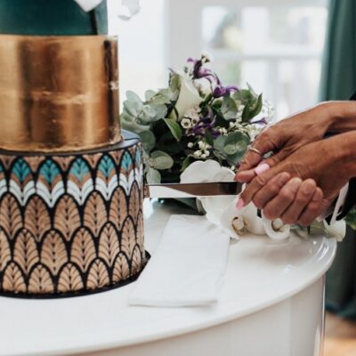 People cutting a cake in a wedding setting