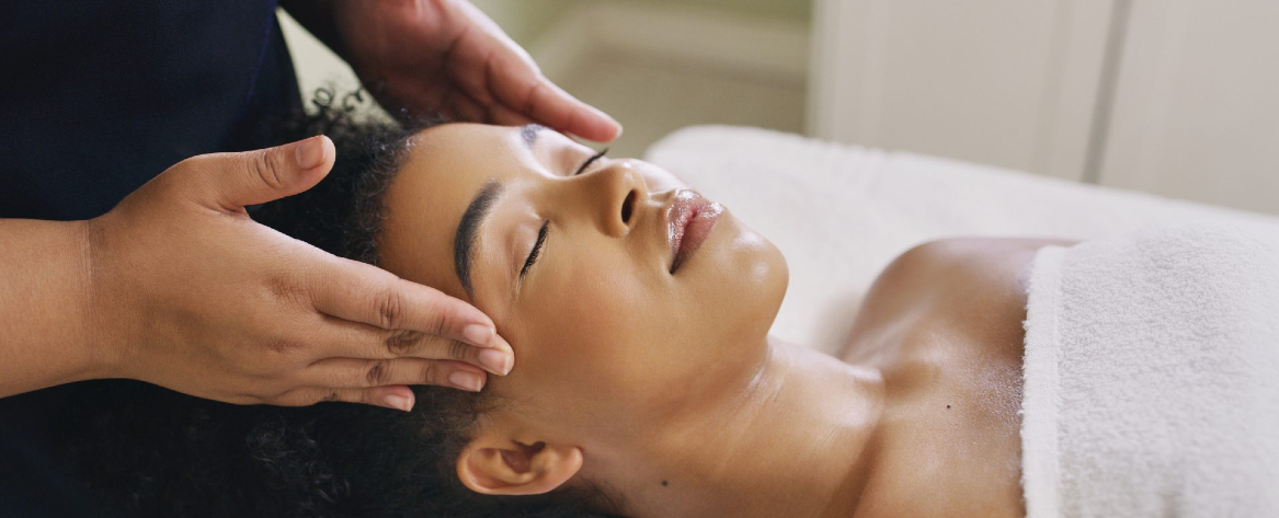 Woman with eyes closed getting a facial treatment