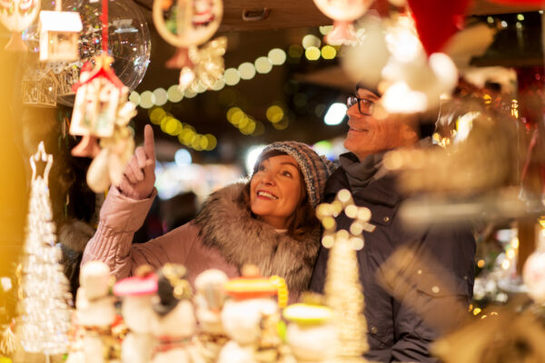 senior couple at christmas market souvenir shop