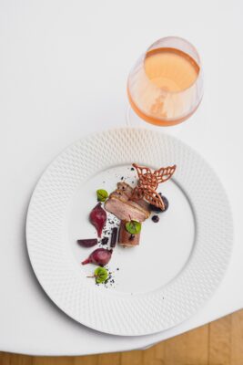 Starter and glass of wine on a white tablecloth in Burgh Island Hotel